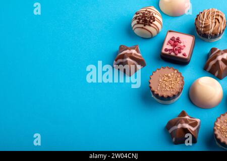 photo, a set of assorted chocolates forms a tempting array of sweet delights. Each piece, with its unique flavor profile, contributes to a tasty assort Stock Photo