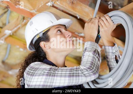 a female worker is working with cables Stock Photo