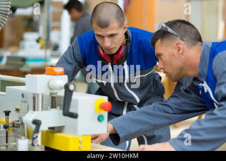 two concentrated workers in factory Stock Photo