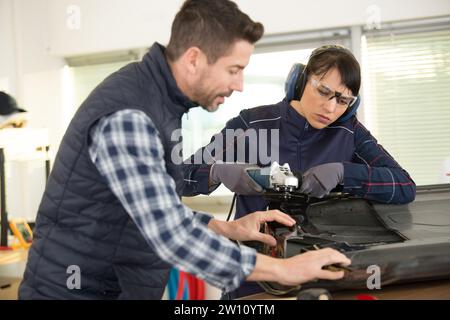 two professional mechanics working together Stock Photo