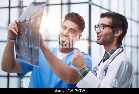Two caucasian doctors view mri picture and discussing about it. Close up. Stock Photo