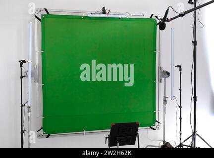 Setup in a TV studio with green screen, lights, and camera Stock Photo