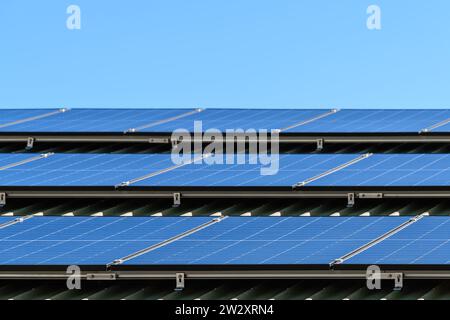 New solar panels installed on the roof of a house in South Australia against a clear blue sky Stock Photo