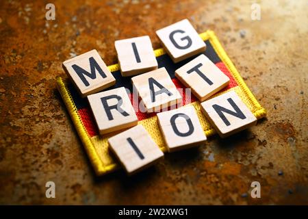 Schriftzug Migration auf Fahne von Deutschland, Symbolfoto Migrationskrise Stock Photo