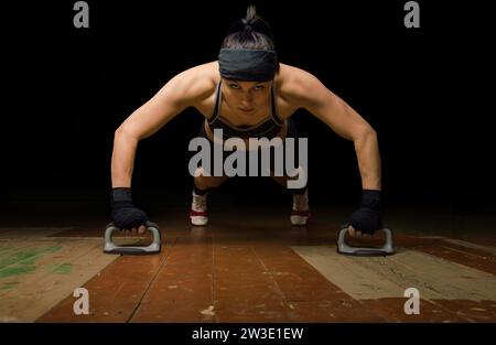 Champion of the world in Thai boxing to prepare for the next competition. Push-ups from the floor in the gym Stock Photo