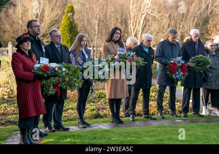 People gather to pay their respects at a wreath laying ceremony to mark the 35th anniversary of the Lockerbie bombing at the Memorial Garden, Dryfesdale Cemetery, Lockerbie. On December 21, 1988, Pan Am Flight 103 exploded over the town in Dumfries and Galloway, 40 minutes into its flight from London to New York. All 259 passengers and crew were killed, including 35 students from the University of Syracuse, along with 11 Lockerbie residents. Picture date: Thursday December 21, 2023. Stock Photo