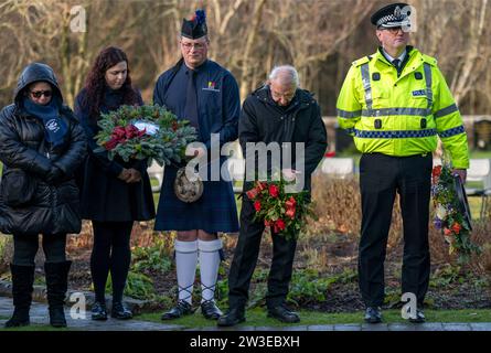 People gather to pay their respects at a wreath laying ceremony to mark the 35th anniversary of the Lockerbie bombing at the Memorial Garden, Dryfesdale Cemetery, Lockerbie. On December 21, 1988, Pan Am Flight 103 exploded over the town in Dumfries and Galloway, 40 minutes into its flight from London to New York. All 259 passengers and crew were killed, including 35 students from the University of Syracuse, along with 11 Lockerbie residents. Picture date: Thursday December 21, 2023. Stock Photo