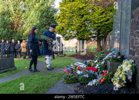 People gather to pay their respects at a wreath laying ceremony to mark the 35th anniversary of the Lockerbie bombing at the Memorial Garden, Dryfesdale Cemetery, Lockerbie. On December 21, 1988, Pan Am Flight 103 exploded over the town in Dumfries and Galloway, 40 minutes into its flight from London to New York. All 259 passengers and crew were killed, including 35 students from the University of Syracuse, along with 11 Lockerbie residents. Picture date: Thursday December 21, 2023. Stock Photo