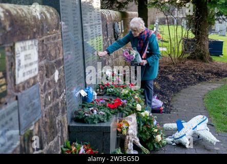 People gather to pay their respects at a wreath laying ceremony to mark the 35th anniversary of the Lockerbie bombing at the Memorial Garden, Dryfesdale Cemetery, Lockerbie. On December 21, 1988, Pan Am Flight 103 exploded over the town in Dumfries and Galloway, 40 minutes into its flight from London to New York. All 259 passengers and crew were killed, including 35 students from the University of Syracuse, along with 11 Lockerbie residents. Picture date: Thursday December 21, 2023. Stock Photo