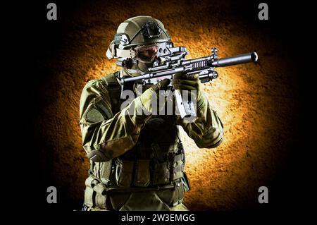 Fighter of a special unit is aiming at the sight of the machine gun. Mixed media Stock Photo