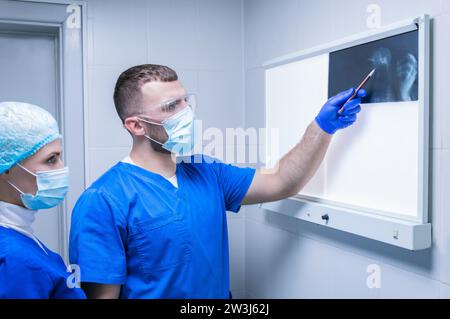 Two doctors are examining an X-ray. Radiology. Medical concept. Mixed media Stock Photo