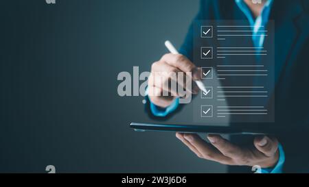 Checklist and filling survey form online. Document management system, DMS. Quality control and accuracy Check, Businessman using tablet online survey Stock Photo