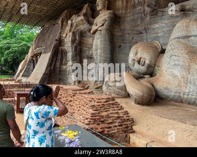Praying woman in front of a reclining Buddha statue, Gal Vihara, Polonnaruwa, Sri Lanka Stock Photo
