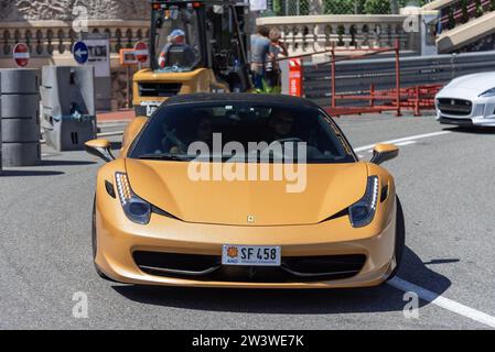 Monaco, Monaco - Yellow Ferrari 458 Italia driving on the road in the Fairmont Hairpin. Stock Photo