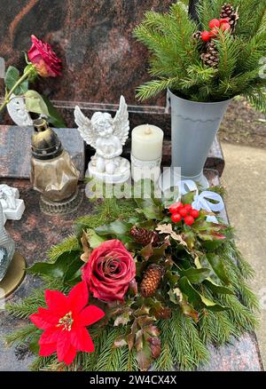 Wreath and lantern on a tombstone in the public cemetery Stock Photo