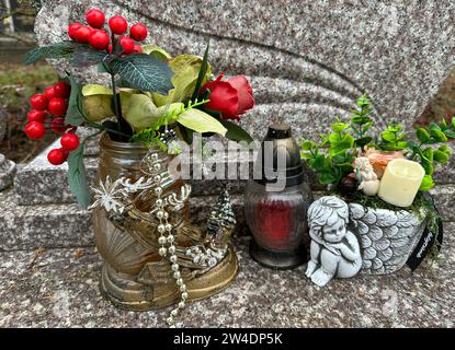 Lantern and angel figurine on a grave in the public cemetery Stock Photo