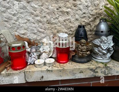 Lanterns and angel figurines on a tombstone in the public cemetery Stock Photo