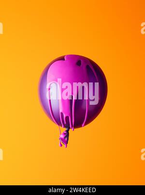Helium ballon covered in pink paint on orange background. Minimal. Stock Photo