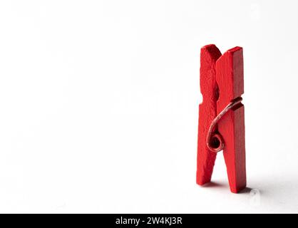 Red wooden clothespin on white background. Minamal concept. Stock Photo