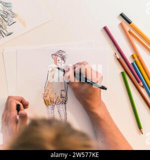 Top view of a fashion designer drawing a fashion sketch Stock Photo