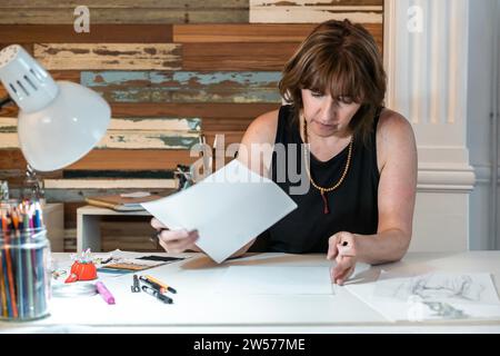 Front view of a fashion desinger working on new designs Stock Photo