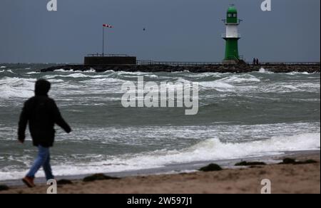 21 December 2023, Mecklenburg-Western Pomerania, Warnemünde: The water of the whipped-up Baltic Sea is pushed onto the beach. Storm depression 'Zoltan' hits large parts of Germany. Gale-force winds are expected in the northern half of the country, with gale-force winds even possible on the North Sea. Photo: Bernd Wüstneck/dpa Stock Photo