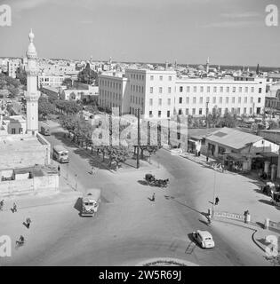 Jamal Pasha street also known as Avenue de la victoire with the postal directorate building and part of a mosque with minaret ca. 1950-1955 Stock Photo