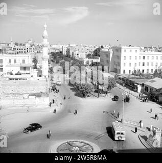 Jamal Pasha street also known as Avenue de la victoire with the postal directorate building and part of a mosque with minaret ca. 1950-1955 Stock Photo