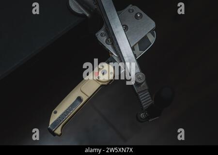 Sharpening folding knife on a machine with diamond stones. High quality photo Stock Photo