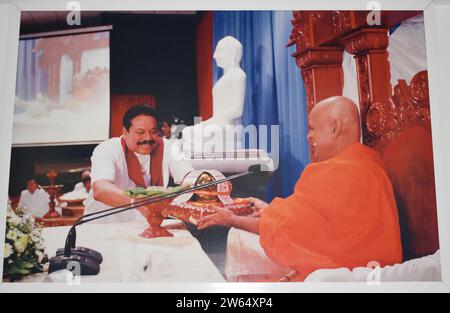 A photograph of former President of Sri Lanka, Mahinda Rajapaksa giving arms to a Chief monk at a temple. He served as the President of Sri Lanka from 2005 to 2015, the Prime Minister of Sri Lanka from 2004 to 2005, 2018, and 2019 to 2022. Colombo, Sri Lanka. Stock Photo