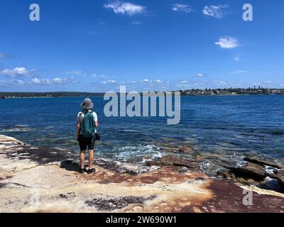 Rear view of a Woman in Royal National Park near Bundeena looking across the Hacking River towards Cronulla, New South Wales, Australia Stock Photo