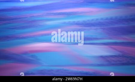 Fluid abstract with waves of purple, blue, and pink, resembling a vibrant twilight sky in motion Stock Photo