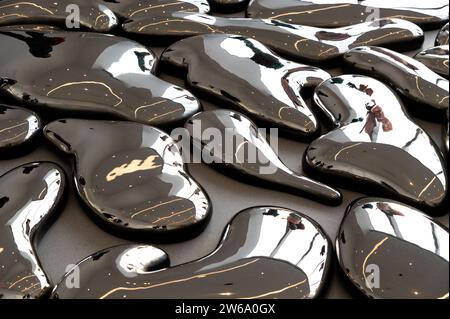 Full frame of monochrome abstract background representing gray colored drops of irregular shapes with shiny surface made of glossy metal fluid Stock Photo