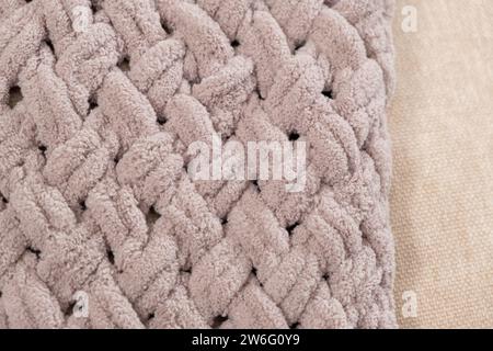 Knitted light pink plaid handmade close-up. Stock Photo