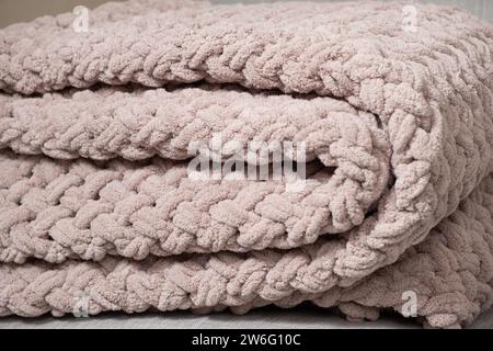 Knitted light pink plaid handmade close-up. Stock Photo