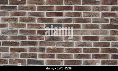 graphic resource of a brown brick wall with white seams as an empty copy space texture, textured background of dark brickwork with light block border Stock Photo