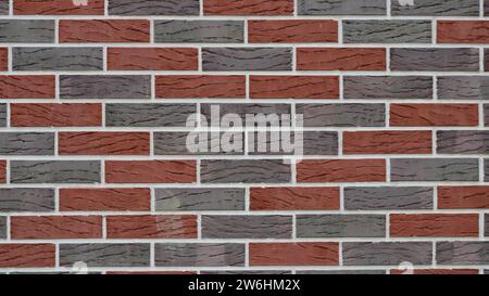 smoothed brick texture in red and gray tones with a decorative pattern on the blocks as an empty background with copy space Stock Photo