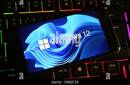 Viersen, Germany - December 9. 2023: Closeup of smartphone on computer keyboard with logo lettering of Microsoft windows 12 Stock Photo