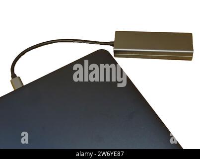 Internet cable connected to a multi-functional USB-C Hub station, Ethernet, which is connected to a laptop Stock Photo
