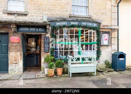 Lacock Village Post Office, Shop and Deli in December wrapped in a green Christmas bow, Lacock, Wiltshire, England, UK Stock Photo