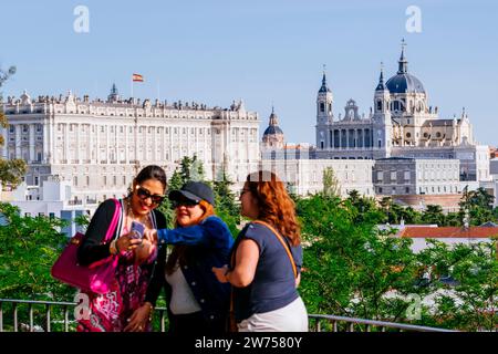 Tourists at the Parque del Oeste Viewpoint, with the Royal Palace, Almudena Cathedral and The Royal Collections Gallery in the background. Madrid, Com Stock Photo