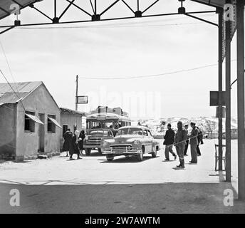 A car and bus at the Syria-Lebanon border post ca. 1950-1955 Stock Photo