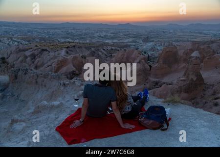05.09.2017, Turkey,      , Nevsehir - Popular viewpoint in the Goereme National Park in Cappadocia, young couple enjoying the sunset. 00A170905D304CAR Stock Photo