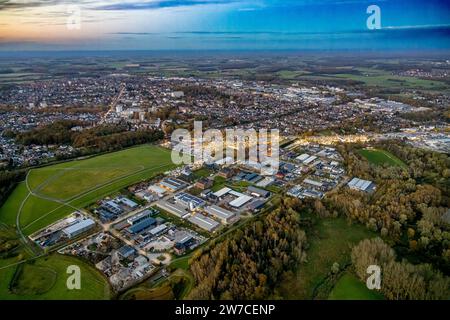 Aerial view, VW car dealership Potthoff with car parking lots in golden evening light, site of Radbod colliery shaft 1 and 2, soccer field Hüserstraße Stock Photo