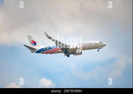 26.07.2023, Singapore, Singapur,  - A Malaysia Airlines Boeing 737-800 passenger aircraft, registration 9M-MLT, approaching Changi International Airpo Stock Photo