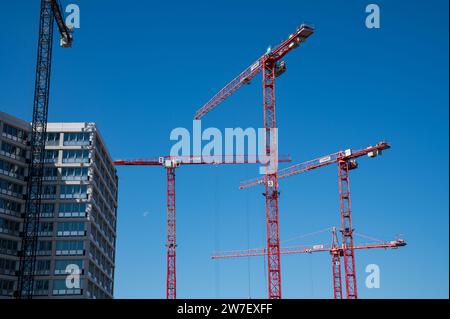 06.09.2023, Germany, Berlin,  - Building cranes tower into the blue sky on a Europacity construction site in the new Heidestrasse neighbourhood in the Stock Photo