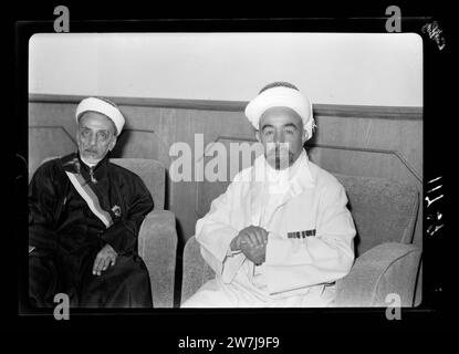 Amman. 24th anniversary of Arab revolt under King Hussein & Lawrence, celebration Sept. 11, 1940. His Highness the Emir Abdullah & Sheikh Abdullah Siraf a Hafai [?]  Seated in reception hall waiting to receive British Resident, etc. Stock Photo