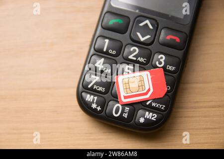 Closeup of an old mobile phone with large keys for elderly users who do not want to use modern smartphones Stock Photo