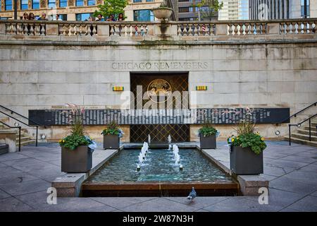 Tourists above Vietnam Veterans Memorial and pigeon bird in front of fountain with flowers, Chicago Stock Photo