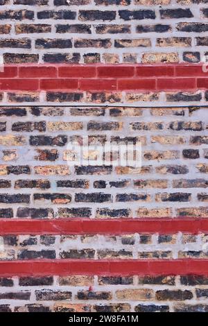 Fading white and black brick wall with red brick lines in background asset Stock Photo